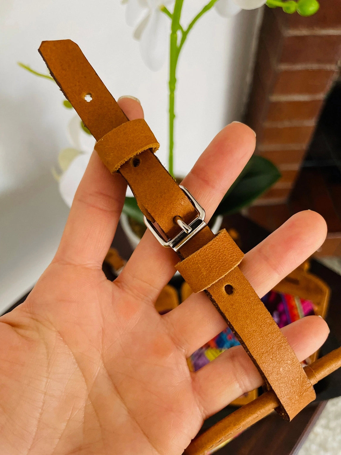 Light brown leather luggage tag with blue, purple and orange embroidered panel